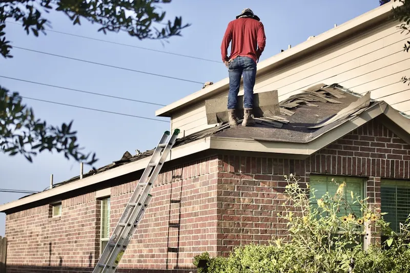 Professional roofer working on a residential roof in Brea Chem